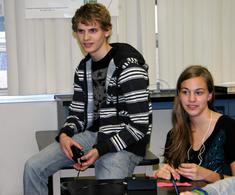 Zach H. -Cal Poly, engineering sitting on a desk and Janel R -Nevada State Chem student sitting in a chair
